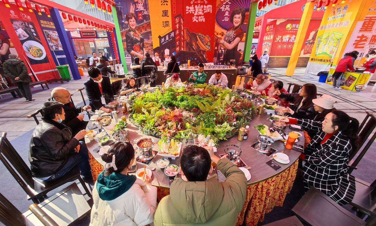 Local residents eat hot pot at a hot pot festival in Southwest China's Chongqing Municipality on January 6, 2023. Photo: VCG