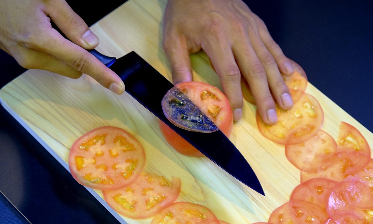 A demonstration to test the sharpness of a knife with a tomato at a factory in Seki, Gifu prefecture, Japan. File photo: AFP