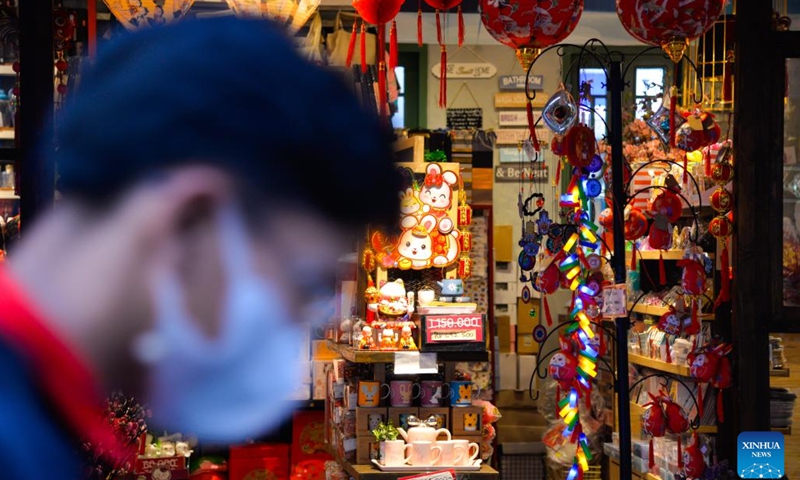 A visitor passes by a shop selling Chinese Lunar New Year decorations at Chinatown in Jakarta, Indonesia, Jan. 12, 2023. As the Chinese Lunar New Year of the Rabbit approaches, the Chinatown in Jakarta is decorated with a variety of decorations, creating a festive atmosphere for visitors.(Photo: Xinhua)