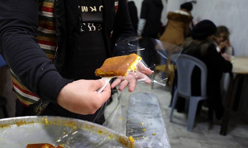 A Palestinian vendor sells Nabulsia, a cheese pastry soaked in sweet sugar-based syrup, at a market in the West Bank city of Nablus, on Jan. 11, 2023.(Photo: Xinhua)