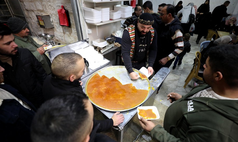 A Palestinian vendor sells Nabulsia, a cheese pastry soaked in sweet sugar-based syrup, at a market in the West Bank city of Nablus, on Jan. 11, 2023.(Photo: Xinhua)