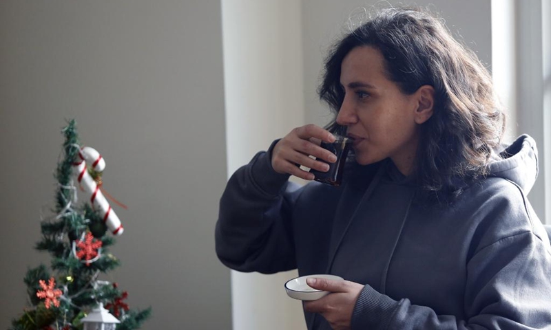 A woman drinks tea at a cafe in Ankara, Türkiye, Jan. 6, 2023. (Photo by Mustafa Kaya/Xinhua)