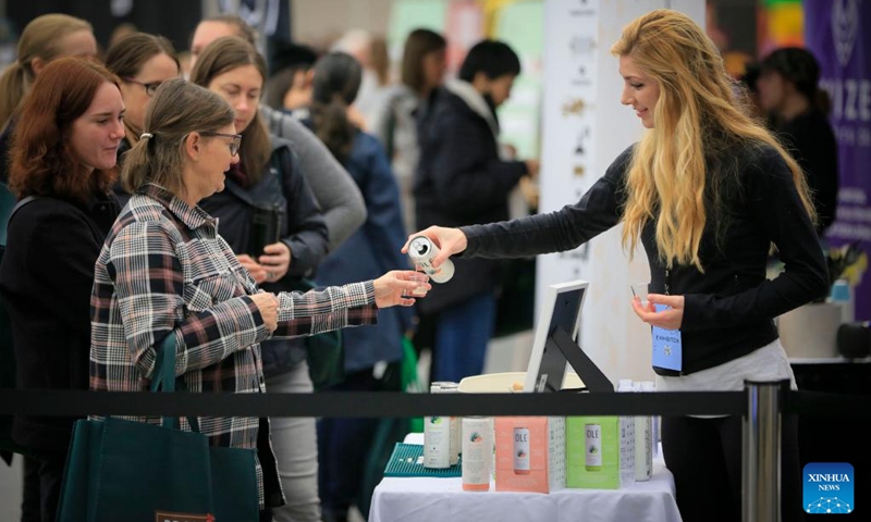 People line up for the gluten-free drink samples at the Gluten Free Expo in Vancouver, British Columbia, Canada, on Jan. 15, 2023. (Photo by Liang Sen/Xinhua)