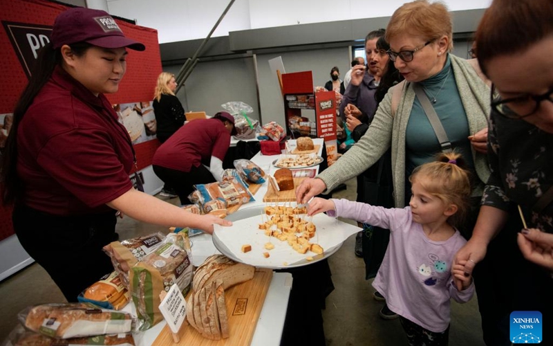 People sample some gluten-free food products at the Gluten Free Expo in Vancouver, British Columbia, Canada, on Jan. 15, 2023. (Photo by Liang Sen/Xinhua)