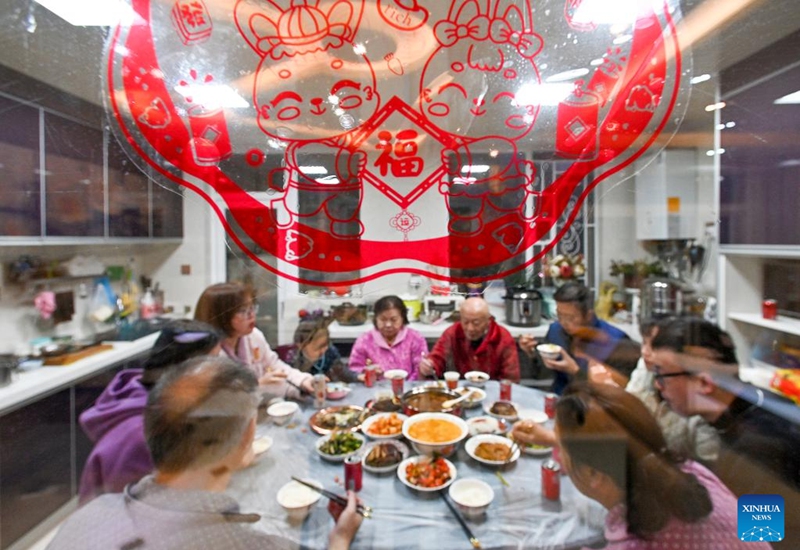 People enjoy a feast on the eve of the Spring Festival in Bijie, southwest China's Guizhou Province, Jan. 21, 2023. On the eve of the Spring Festival in China, while some people reunite with their families and friends, there are others who still stick to their posts away from home. Nevertheless, nothing can stop a warm gathering and a delicious festive dinner while awaiting the arrival of the Spring Festival. (Photo by Li Hua/Xinhua)