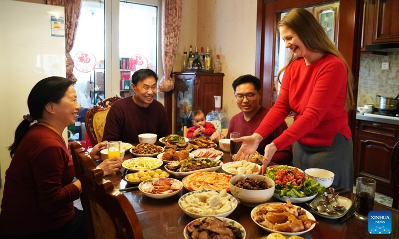 People enjoy a family feast in Beijing, capital of China, Jan. 21, 2023. On the eve of the Spring Festival in China, while some people reunite with their families and friends, there are others who still stick to their posts away from home. Nevertheless, nothing can stop a warm gathering and delicious festive dinner while they await the arrival of the Spring Festival. (Xinhua/Ren Chao)