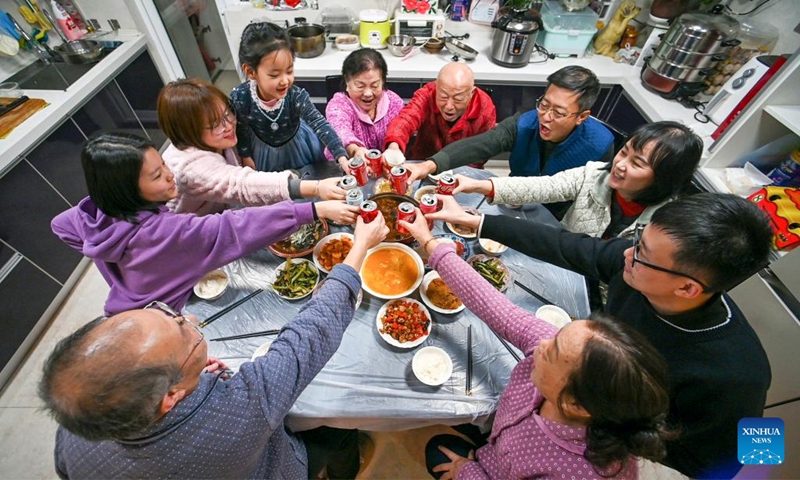 People enjoy a family feast on the eve of the Spring Festival in Bijie, southwest China's Guizhou Province, Jan. 21, 2023. On the eve of the Spring Festival in China, while some people reunite with their families and friends, there are others who still stick to their posts away from home. Nevertheless, nothing can stop a warm gathering and delicious festive dinner while they await the arrival of the Spring Festival. (Photo by Li Hua/Xinhua)