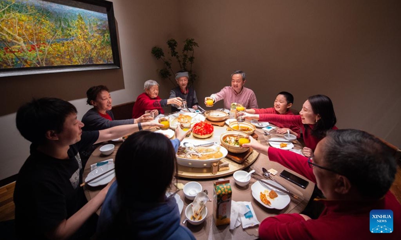 People enjoy a feast at a restaurant in Beijing, capital of China, Jan. 21, 2023. On the eve of the Spring Festival in China, while some people reunite with their families and friends, there are others who still stick to their posts away from home. Nevertheless, nothing can stop a warm gathering and delicious festive dinner while they await the arrival of the Spring Festival. (Xinhua/Chen Zhonghao)