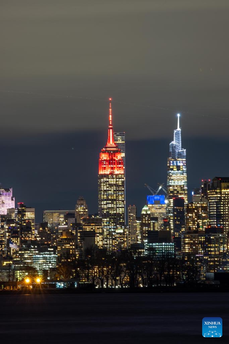 This photo taken on Jan. 20, 2023 shows the Empire State Building lit up in red for the Chinese Lunar New Year, in New York, the United States. (Photo by Winston Zhou/Xinhua)