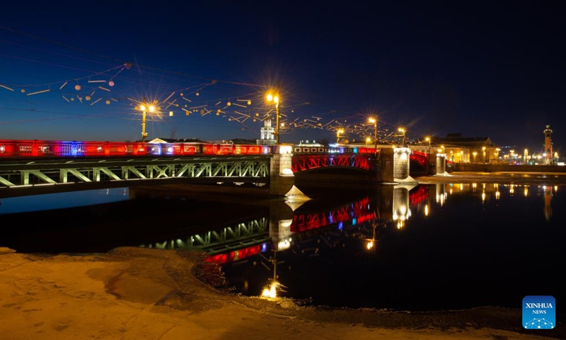 This photo taken on Jan. 21, 2023 shows the Palace Bridge illuminated in red to celebrate the Chinese New Year in St. Petersburg, Russia. (Photo by Irina Motina/Xinhua)