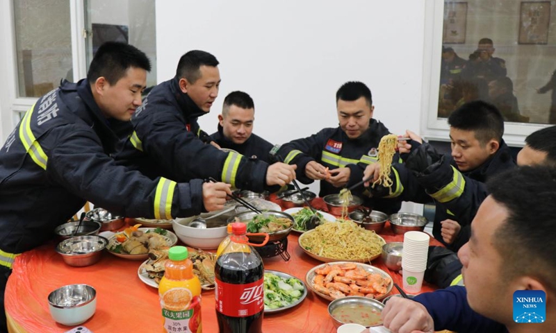 Firefighters enjoy a feast on the eve of the Spring Festival in Longyan, southeast China's Fujian Province, Jan. 21, 2023. On the eve of the Spring Festival in China, while some people reunite with their families and friends, there are others who still stick to their posts away from home. Nevertheless, nothing can stop a warm gathering and delicious festive dinner while they await the arrival of the Spring Festival. (Photo by Zhou Yangdong/Xinhua)