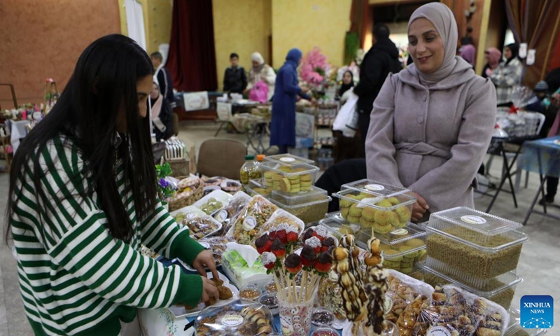 People participate in a bazaar held to support small business owners in the West Bank city of Hebron, on Jan. 21, 2023. (Photo by Mamoun Wazwaz/Xinhua)