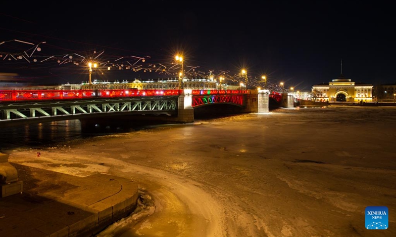 This photo taken on Jan. 21, 2023 shows the Palace Bridge illuminated in red to celebrate the Chinese New Year in St. Petersburg, Russia. (Photo by Irina Motina/Xinhua)