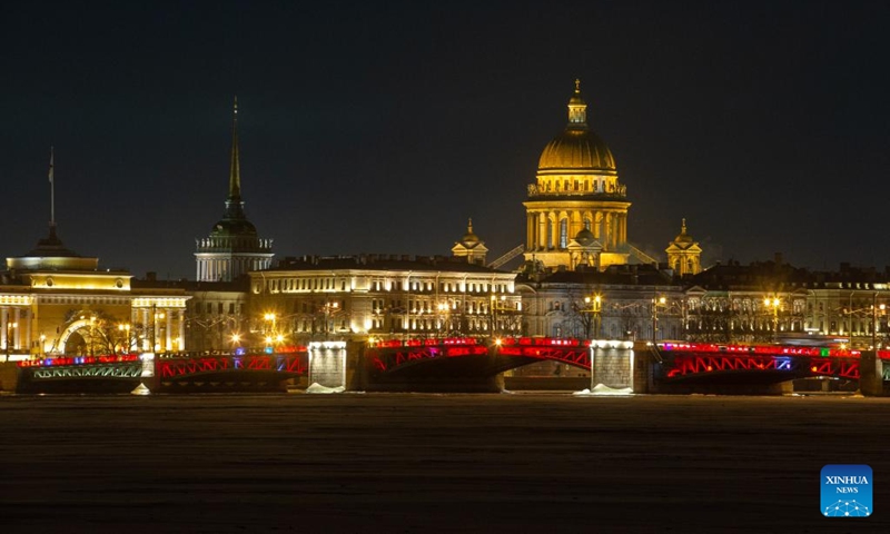 This photo taken on Jan. 21, 2023 shows the Palace Bridge illuminated in red to celebrate the Chinese New Year in St. Petersburg, Russia. (Photo by Irina Motina/Xinhua)