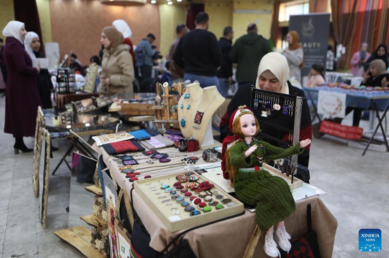 People participate in a bazaar held to support small business owners in the West Bank city of Hebron, on Jan. 21, 2023. (Photo by Mamoun Wazwaz/Xinhua)