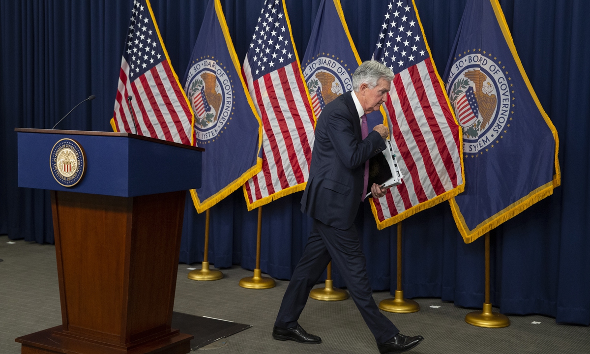 US Federal Reserve Board Chairman Jerome Powell walks away after announcing the increase in interest rate by 25 basis points at a press conference on US time February 1, 2022. The rise was less aggressive than the previous year but the fight against inflation is not over, Powell warned. Photo: IC