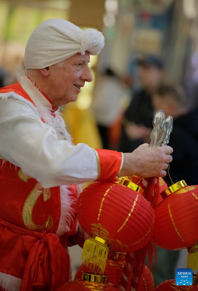 A performer in costume prepares to perform during the Chinese New Year celebration event at Lansdowne Centre in Richmond, British Columbia, Canada, Jan. 28, 2023. The event features a wide variety of cultural activities that allow the audience to experience the traditional culture of the Chinese New Year. (Photo by Liang Sen/Xinhua)