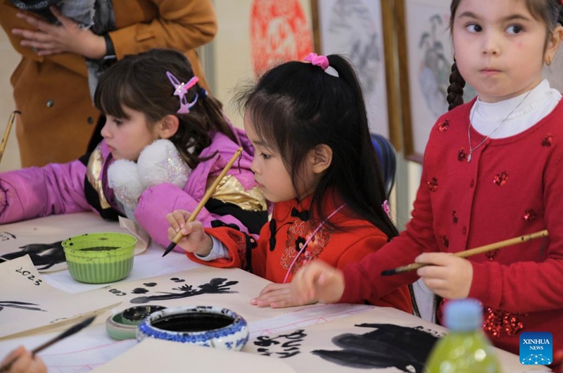 Children paint rabbits with Chinese brushes in Sliema, Malta, Jan. 28, 2023. An event to celebrate the Chinese New Year or Spring Festival was held in a shopping mall in Sliema on Saturday. (Photo by Jonathan Borg/Xinhua)