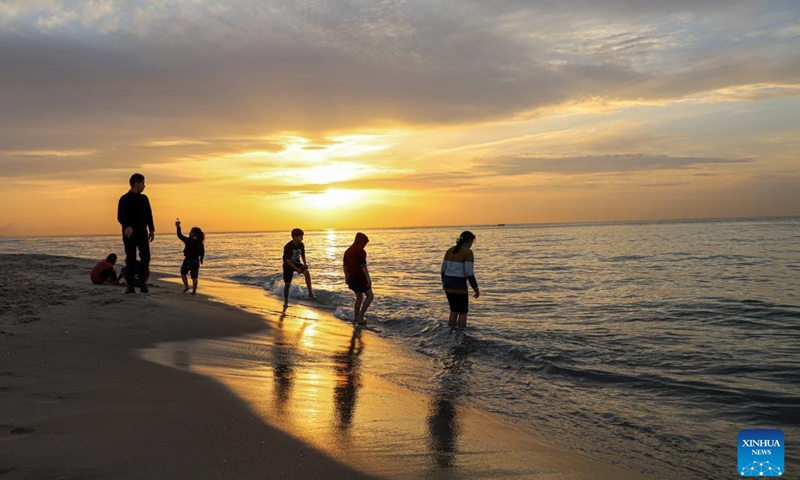 People have fun at sunset on a beach of the Mediterranean Sea in Gaza City, on Jan. 27, 2023.(Photo: Xinhua)