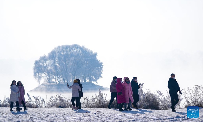 People enjoy the rime scenery near the Songhua River in Jilin City, northeast China's Jilin Province, Jan. 30, 2023.(Photo: Xinhua)