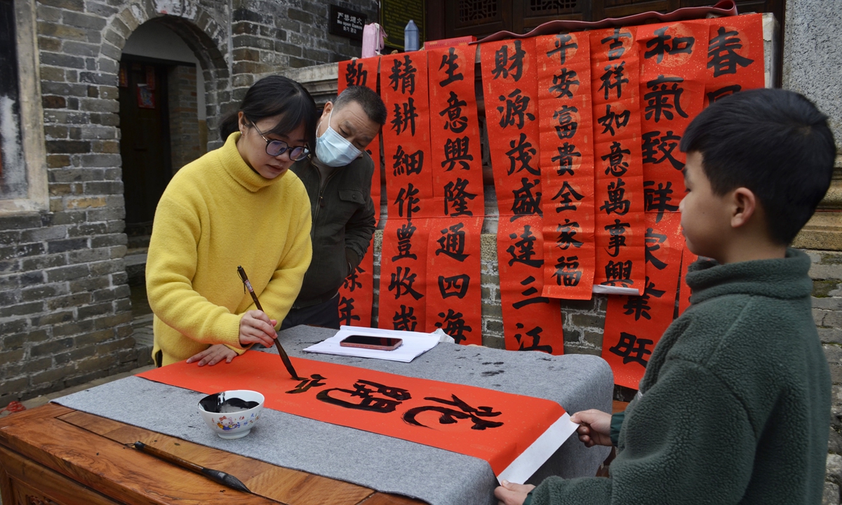 A young lady writes Spring Festival couplets on January 16, 2023 in Qinzhou, Guangxi Zhuang Autonomous Region. Photo: VCG