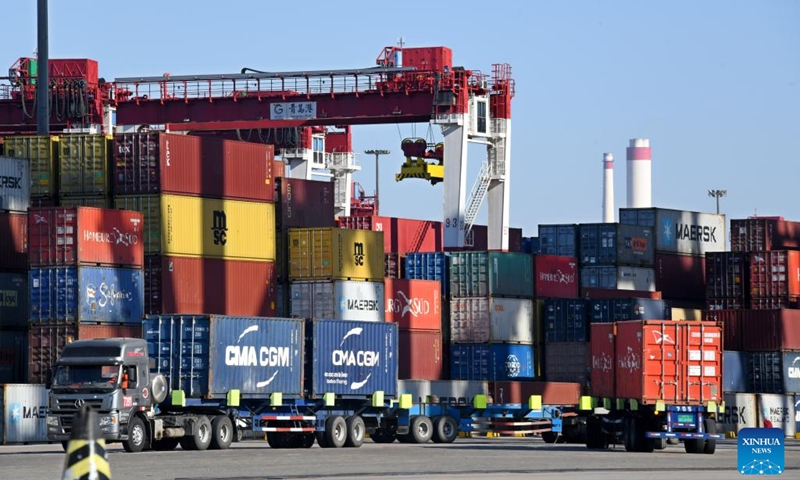 Trucks transport containers at Qianwan Container Terminal of Qingdao Port in east China's Shandong Province, Jan. 27, 2023.(Photo: Xinhua)