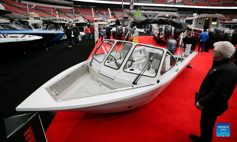 A visitor looks at a speedboat at the 2023 Vancouver International Boat Show in Vancouver, British Columbia, Canada, on Feb. 1, 2023. The five-day boat show, featuring over 200 exhibitors from across the world, showcases a wide selection of boats and related accessories.(Photo: Xinhua)