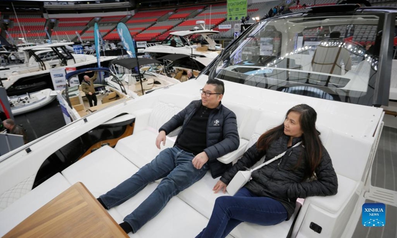 Visitors sit on the deck of a yacht at the 2023 Vancouver International Boat Show in Vancouver, British Columbia, Canada, on Feb. 1, 2023. The five-day boat show, featuring over 200 exhibitors from across the world, showcases a wide selection of boats and related accessories.(Photo: Xinhua)