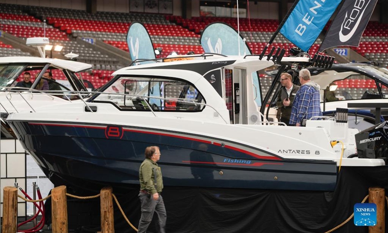 Visitors look at a yacht at the 2023 Vancouver International Boat Show in Vancouver, British Columbia, Canada, on Feb. 1, 2023. The five-day boat show, featuring over 200 exhibitors from across the world, showcases a wide selection of boats and related accessories.(Photo: Xinhua)