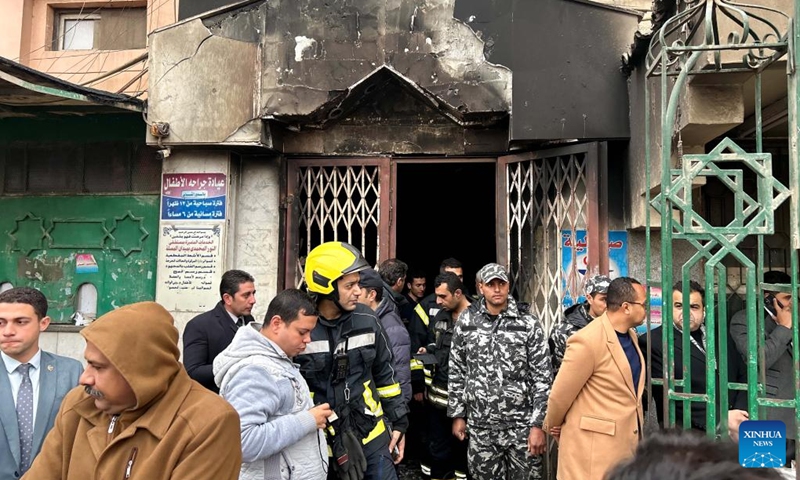 People gather outside a hospital where a fire broke out in Cairo, Egypt, on Feb. 1, 2023. At least three people were killed and 32 others wounded in a fire that broke out Wednesday at the charitable hospital in Cairo, said the Egyptian Health Ministry in a statement.(Photo: Xinhua)