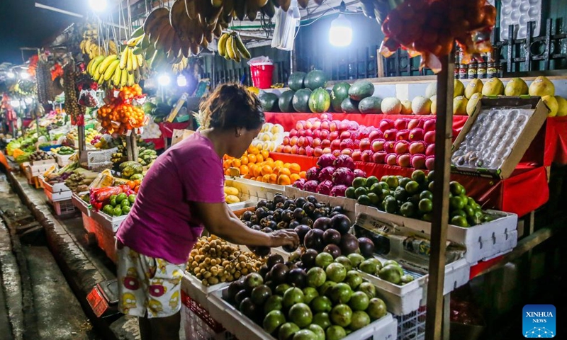 A vendor arranges fruits at a market in Quezon City, the Philippines, Feb. 7, 2023. Inflation in the Philippines accelerated to 8.7 percent in January year-on-year, the highest monthly rate since November 2008, the Philippine Statistics Authority (PSA) said on Tuesday.(Photo: Xinhua)