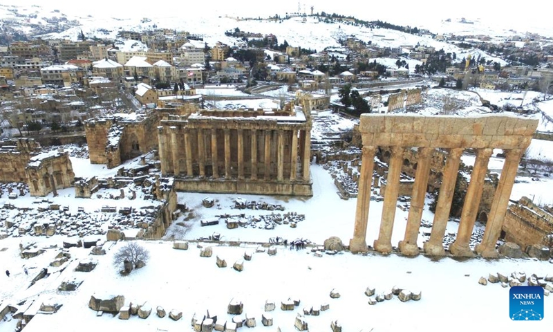 This photo taken on Feb. 7, 2023 shows the snow scenery of Roman ruins in the city of Baalbek, Lebanon. (Photo by Taher Abu Hamdan/Xinhua)