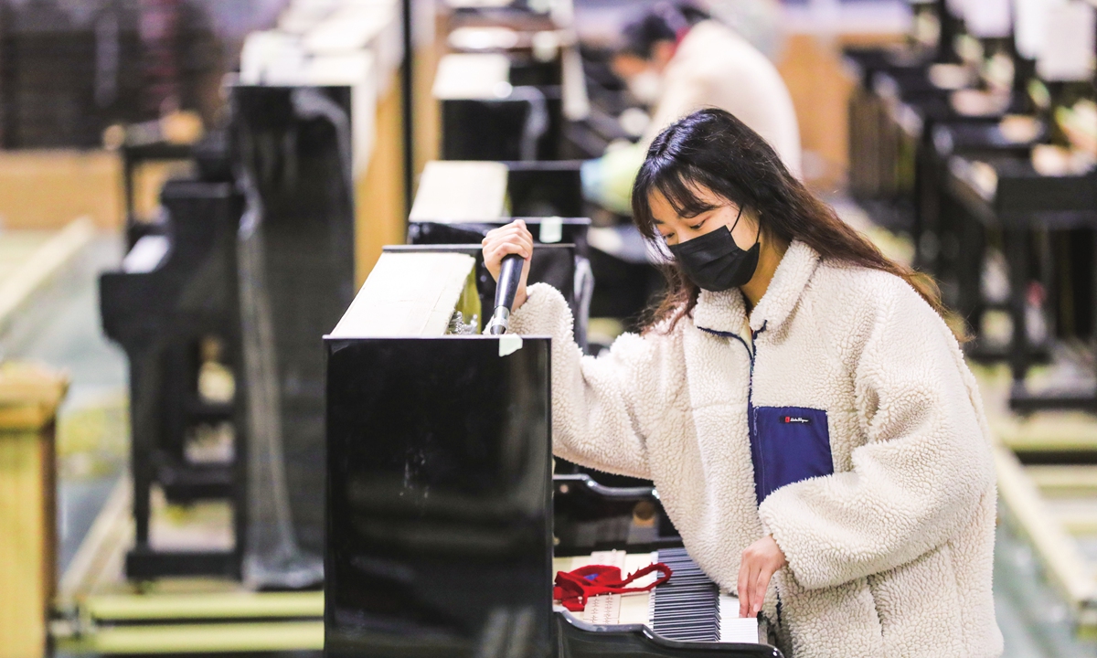 Workers tune pianos at a factory in Luoshe town of Huzhou, East China's Zhejiang Province on February 9, 2023. The town has nearly 100 piano enterprises, with an annual output of more than 50,000 pianos, and the total output value of the sector is about 500 million yuan ($73.78 million). Photo: cnsphoto