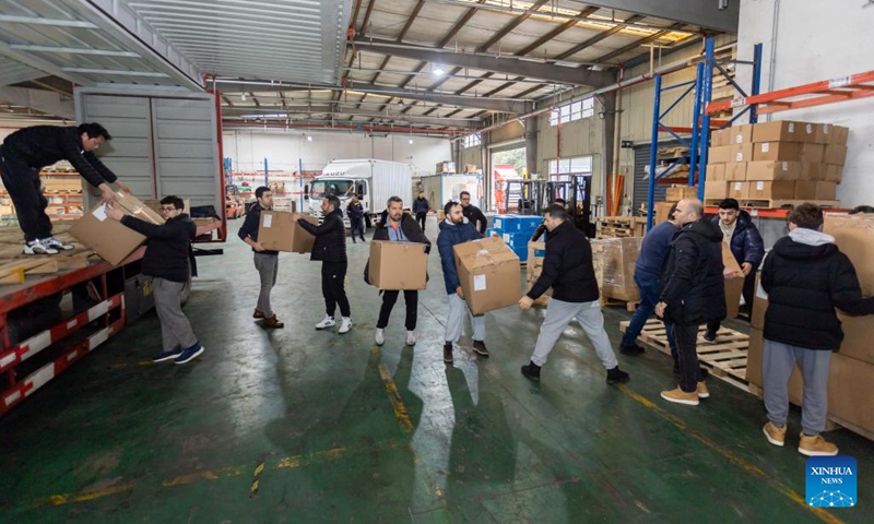 Volunteers transport earthquake relief supplies donated to Türkiye at a warehouse of Shanghai Pudong International Airport in east China's Shanghai, Feb. 11, 2023. A batch of earthquake relief supplies donated to Türkiye from various sectors in Shanghai has recently arrived at a warehouse of Shanghai Pudong International Airport. The supplies will be delivered to Türkiye in the coming few days.(Photo: Xinhua)