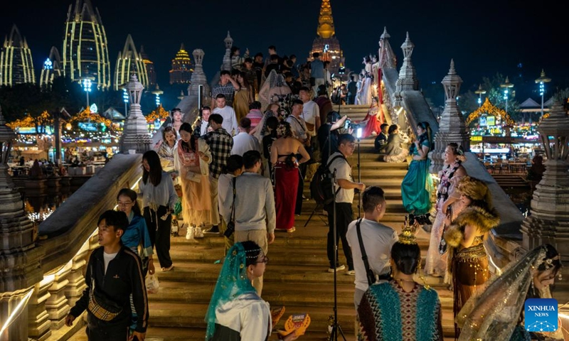 Tourists are pictured at a night fair in Jinghong City, Xishuangbanna Dai Autonomous Prefecture, southwest China's Yunnan Province, Feb. 13, 2023. Xishuangbanna received over 2.7175 million visits during this year's Spring Festival holiday, up 554.51 percent year on year, according to local culture and tourism department.(Photo: Xinhua)