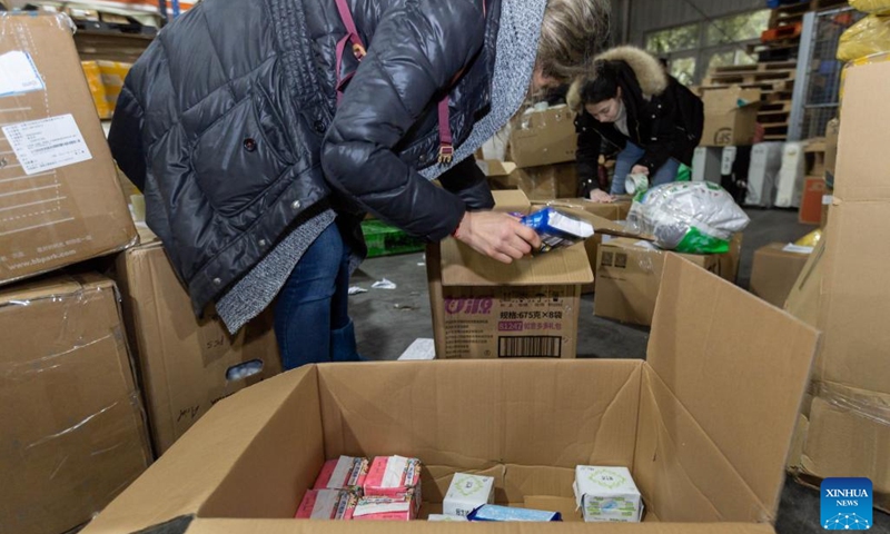 Volunteers arrange earthquake relief supplies donated to Türkiye at a warehouse of Shanghai Pudong International Airport in east China's Shanghai, Feb. 11, 2023. A batch of earthquake relief supplies donated to Türkiye from various sectors in Shanghai has recently arrived at a warehouse of Shanghai Pudong International Airport. The supplies will be delivered to Türkiye in the coming few days.(Photo: Xinhua)