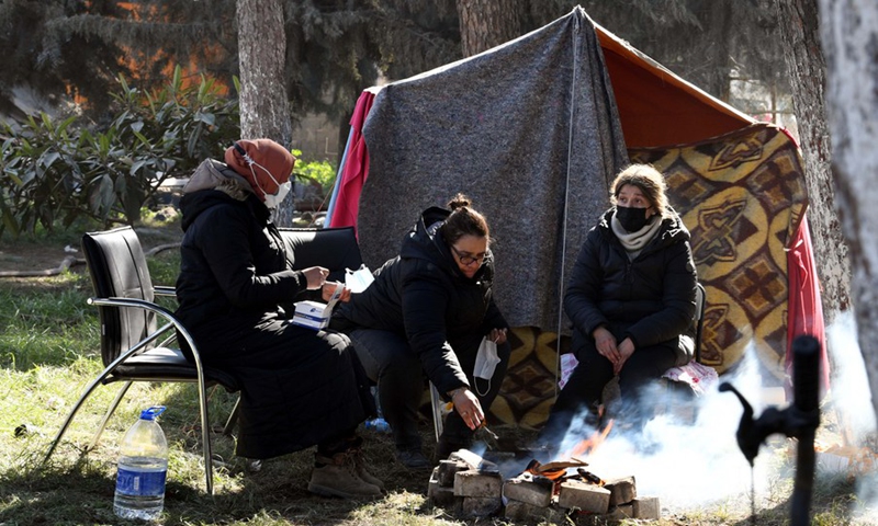 People rest by their temporary shelter in Antakya in the southern province of Hatay, Türkiye, Feb. 14, 2023.(Photo: Xinhua)