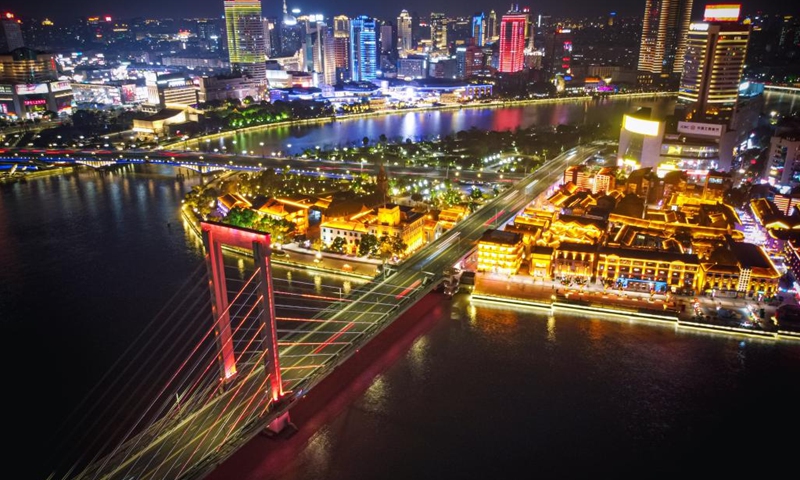 This aerial photo taken on Feb. 15, 2023 shows the night view of Laowaitan, a signature pedestrian street in Ningbo, east China's Zhejiang Province. As the temperature gradually rises, a series of activities such as night market and iron flowers, a performance of splashing molten iron to create fireworks, are held at Laowaitan to enrich the night life of citizens and tourists.(Photo: Xinhua)