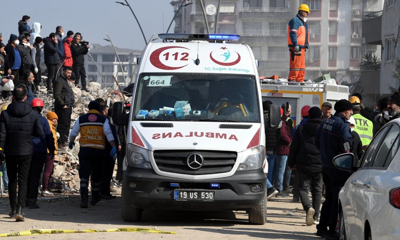 An ambulance is seen near earthquake debris in Antakya in the southern province of Hatay, Türkiye, Feb. 13, 2023.(Photo: Xinhua)