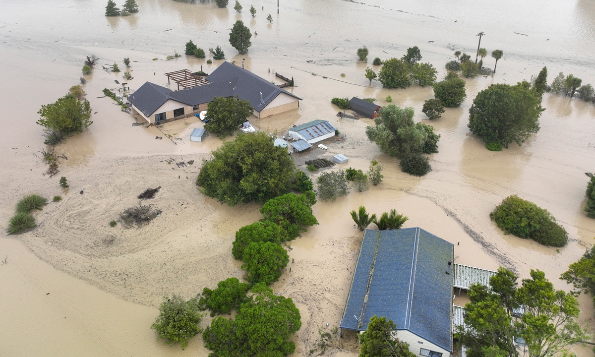 Houses and fields are submerged by floods caused by Cyclone Gabrielle in Awatoto, near the city of Napier on February 14, 2023. New Zealand declared a national state of emergency after the cyclone swept away roads, inundated homes and left more than 100,000 people without power. Photo: AFP