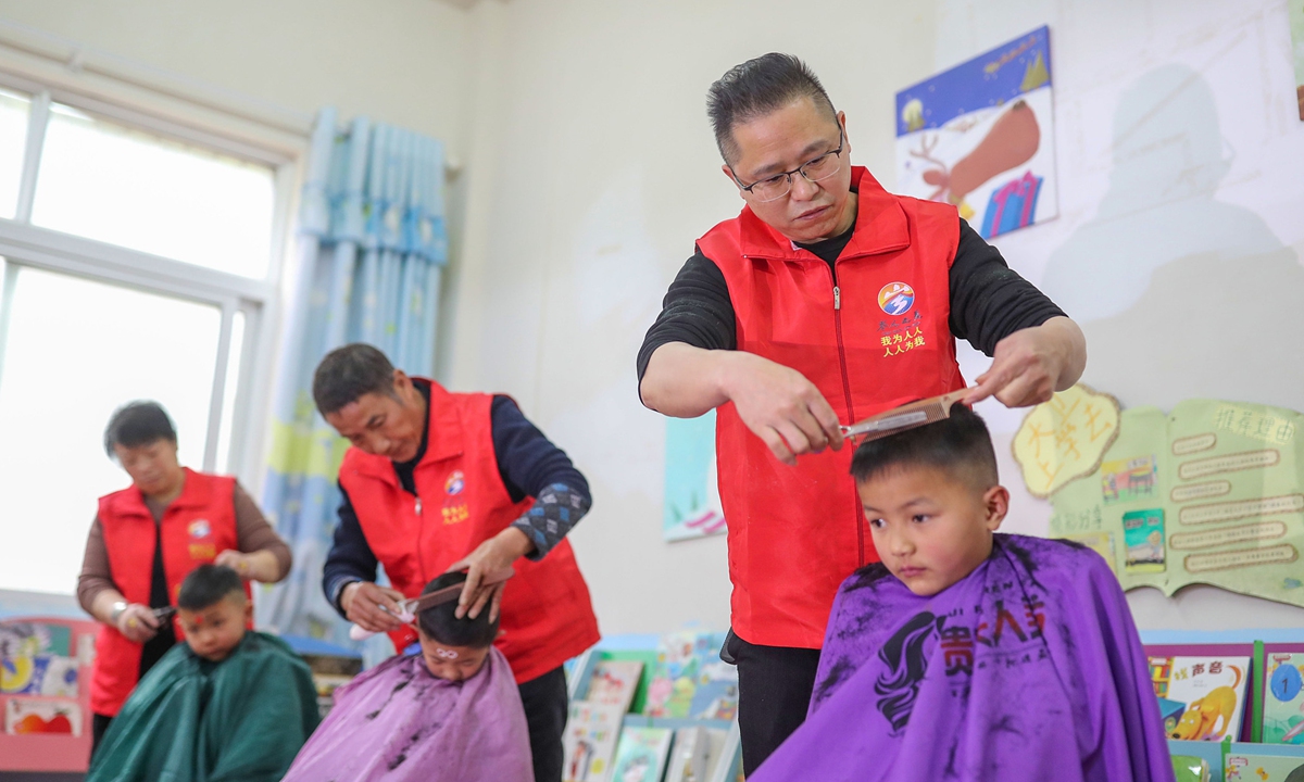 Volunteers give children free haircuts in a kindergarten in Qiandongnan, Southwest China's Guizhou Province on February 21, 2023. The day falls on the second day of the second lunar month, also known as China's Dragon-Head-Raising Festival. Photo: VCG