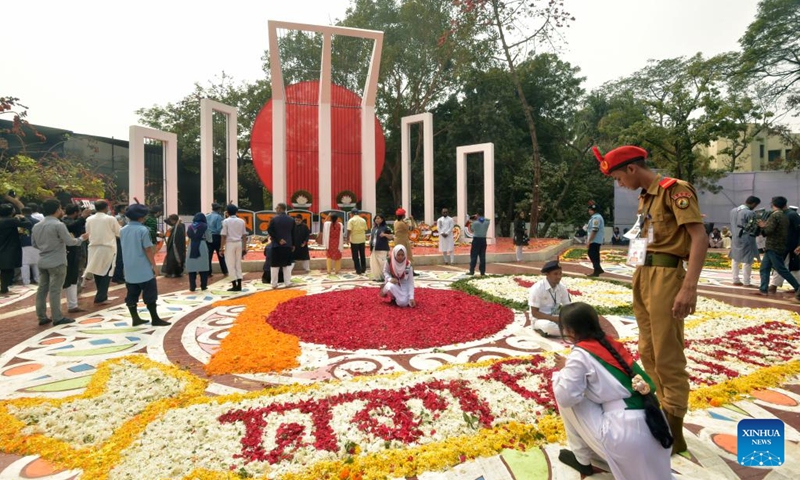 Volunteers decorate the Central Shaheed Minar, a solemn and iconic monument, in Dhaka, Bangladesh on Feb. 21, 2023. Hundreds of thousands of people in Bangladeshi capital Dhaka Tuesday paid tributes to the country's language movement activists who sacrificed their lives on the day in 1952.(Photo: Xinhua)