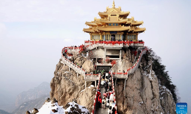 Tourists visit the Laojun Mountain scenic spot in Luanchuan County of Luoyang, central China's Henan Province, Feb. 23, 2023. Official data showed that the city saw 10.31 million trips in January of 2023, generating 6.28 billion yuan (about 902.44 million U.S. dollars) in revenue, up 746.63 percent and 690.06 percent year on year respectively.(Photo: Xinhua)