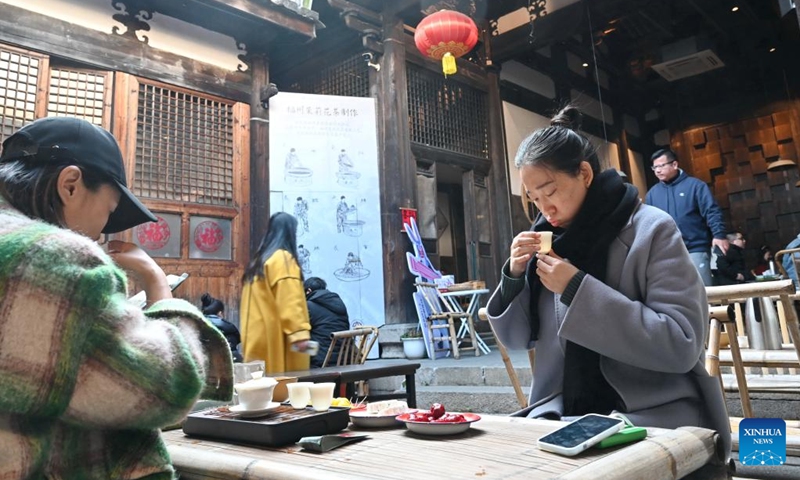 People drink tea at a tea house in the Shangxiahang traditional block in Fuzhou, southeast China's Fujian Province, Feb. 26, 2023. The time-honored tea culture has contributed to the thriving of tea houses in Fuzhou.(Photo: Xinhua)