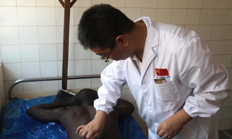 A member of the 25th Chinese medical team dispatched to Togo inquires a local patient at the Medical Center of Pya in Kara, Togo, Feb. 25, 2023. The 25th Chinese medical team dispatched to Togo on Saturday provided free medical services for more than 600 local patients at the Medical Center of Pya in Kara and donated medical supplies. The medical services included internal medicine, general surgery, obstetrics and gynecology, orthopedics, and traditional Chinese acupuncture. (Xinhua)