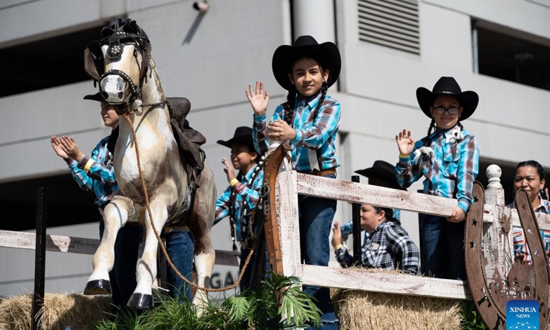 Young cowgirls riding a float are pictured during the 91st Downtown Rodeo Parade in Houston, Texas, the United States, Feb. 25, 2023. (Photo by Chen Chen/Xinhua)