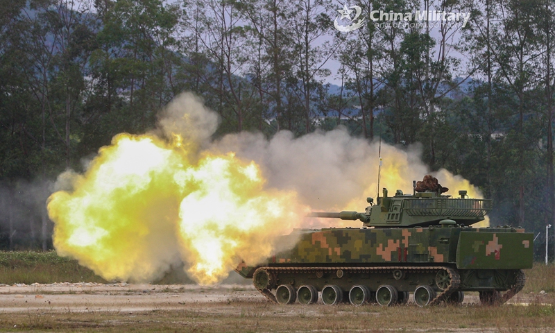 An amphibious armored assault vehicle attached to the PLA 74th Group Army spits fire at simulated target during a recent live-fire training exercise. (eng.chinamil.com.cn/Photo by Li Bin)