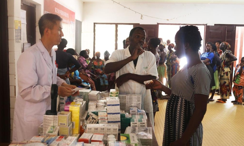 A member of the 25th Chinese medical team dispatched to Togo gives medicines to a local patient at the Medical Center of Pya in Kara, Togo, Feb. 25, 2023. The 25th Chinese medical team dispatched to Togo on Saturday provided free medical services for more than 600 local patients at the Medical Center of Pya in Kara and donated medical supplies. The medical services included internal medicine, general surgery, obstetrics and gynecology, orthopedics, and traditional Chinese acupuncture. (Xinhua)