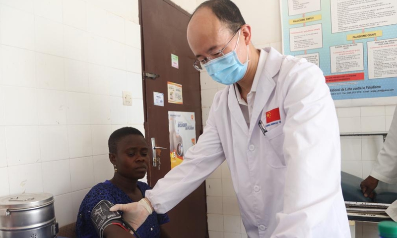 A member of the 25th Chinese medical team dispatched to Togo inquires a local patient at the Medical Center of Pya in Kara, Togo, Feb. 25, 2023. The 25th Chinese medical team dispatched to Togo on Saturday provided free medical services for more than 600 local patients at the Medical Center of Pya in Kara and donated medical supplies. The medical services included internal medicine, general surgery, obstetrics and gynecology, orthopedics, and traditional Chinese acupuncture. (Xinhua)