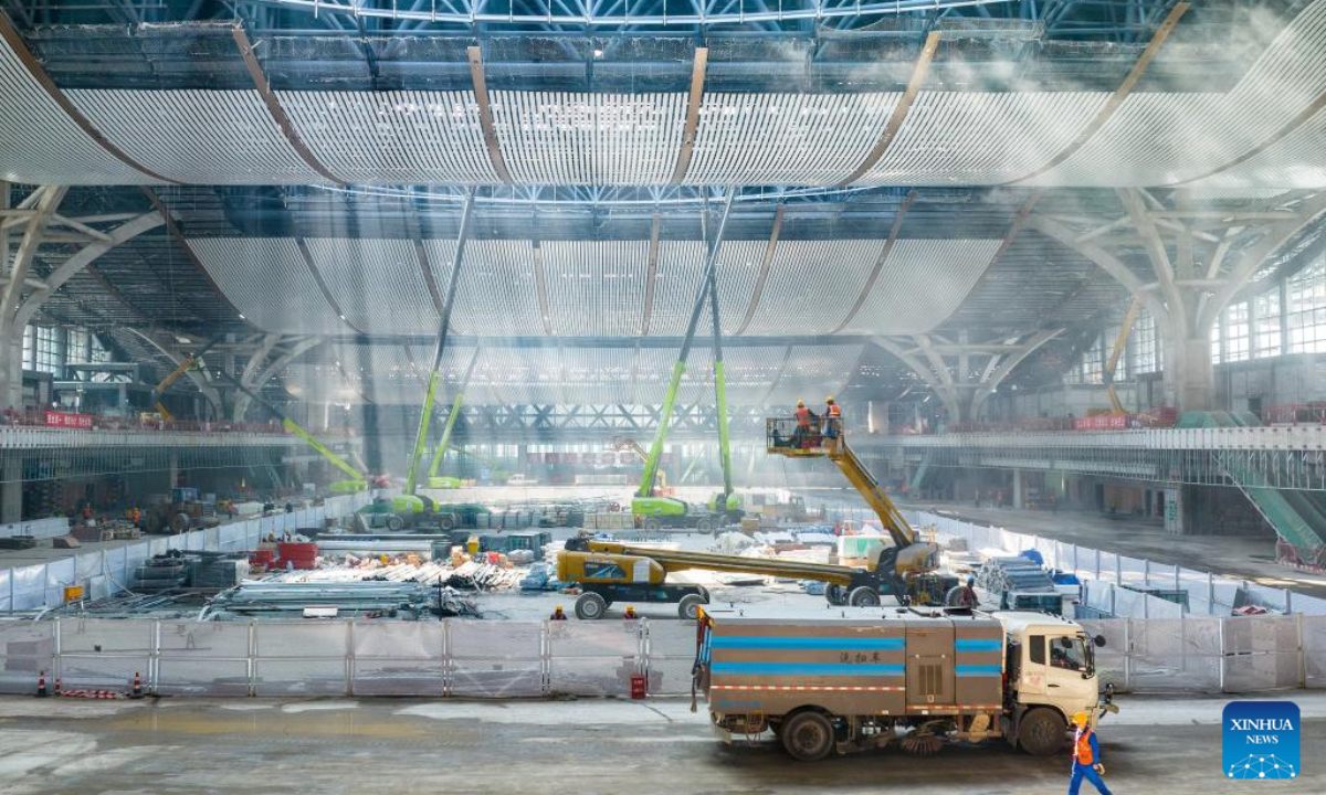 Workers install the suspended ceiling at the waiting hall of Xiamen North Railway Station of the new Fuzhou-Xiamen high-speed railway in Xiamen, southeast China's Fujian Province, Feb 23, 2023. Photo:Xinhua